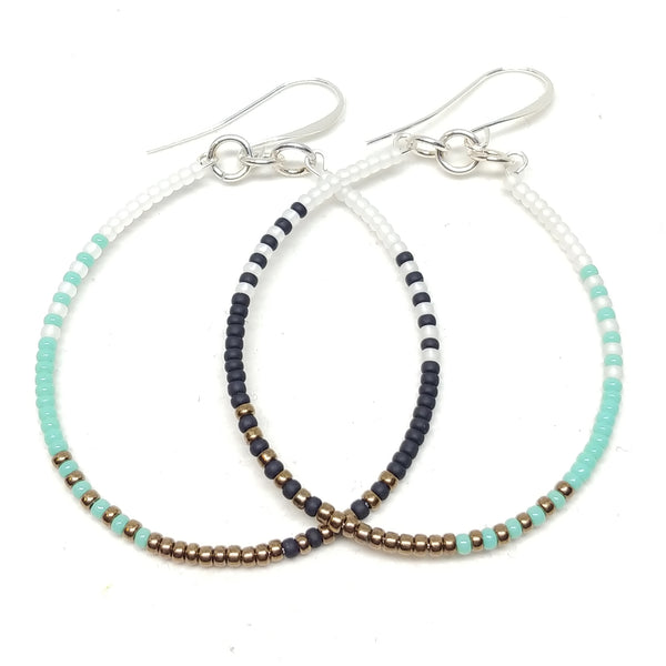 Calm Hoops: Silver-plated ear wires, 2" hoops, white, black, bronze and turquoise seed beads.