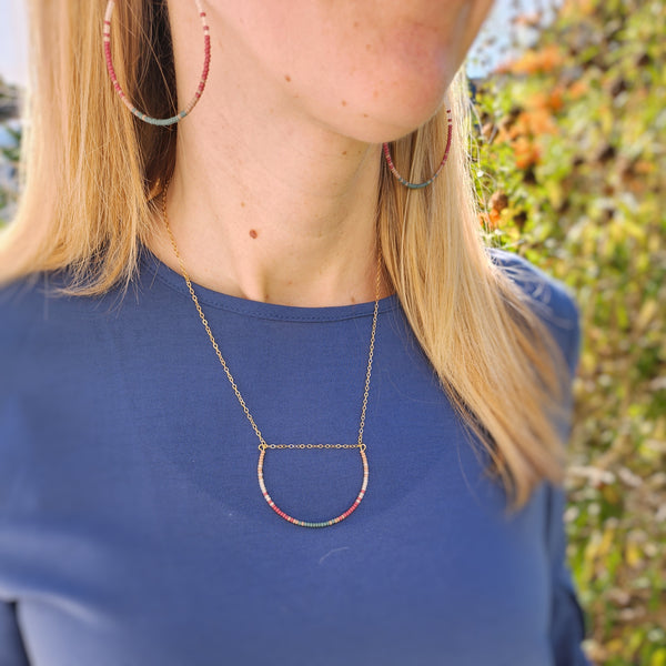 Model wearing hoops and necklace.