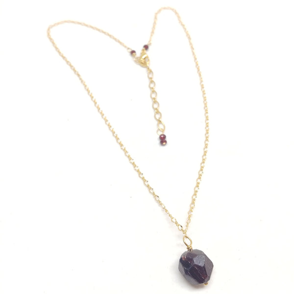 Gold plated delicate chain necklace with a raw garnet bead pendant