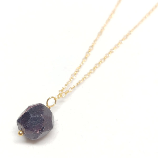 Gold plated delicate chain necklace with a raw garnet bead pendant