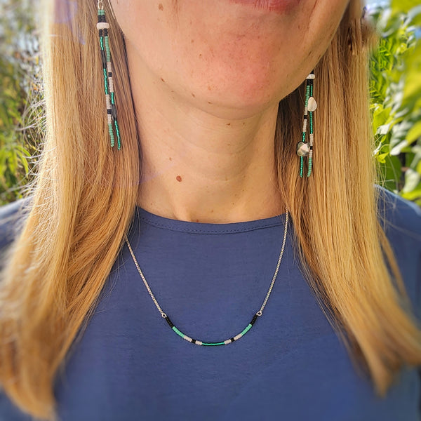 Model wearing necklace and dangles