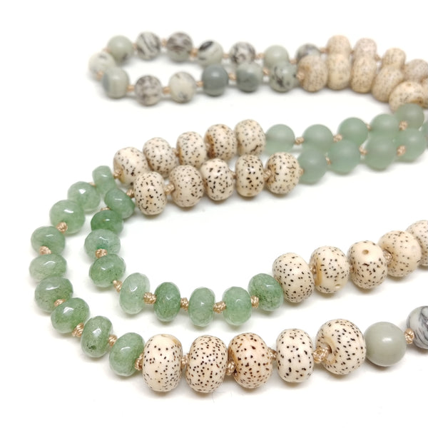 Detail of Culp Valley Necklace, long 108 bead knotted mala necklace, grass jasper, aventurine, bodhi seeds, brass sunburst pendant