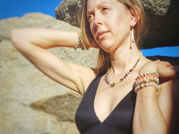 Model wearing stack bracelets