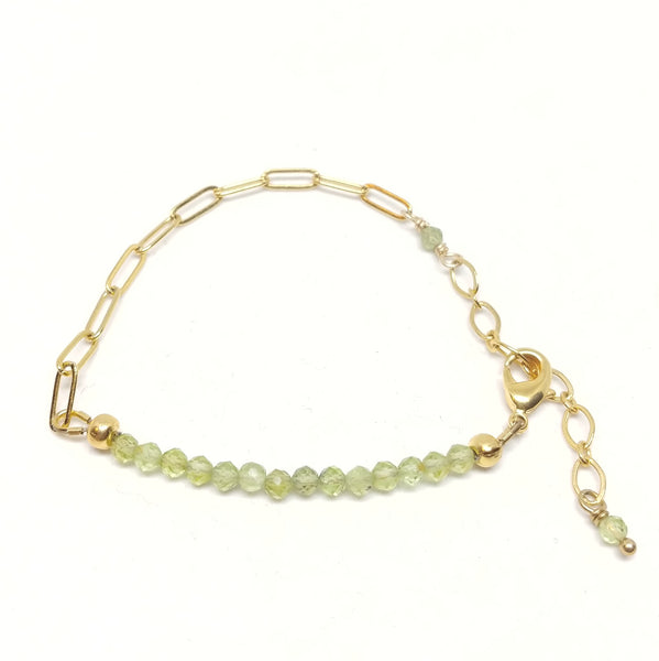 August birthstone peridot bracelet on gold-plated paper clip chain.