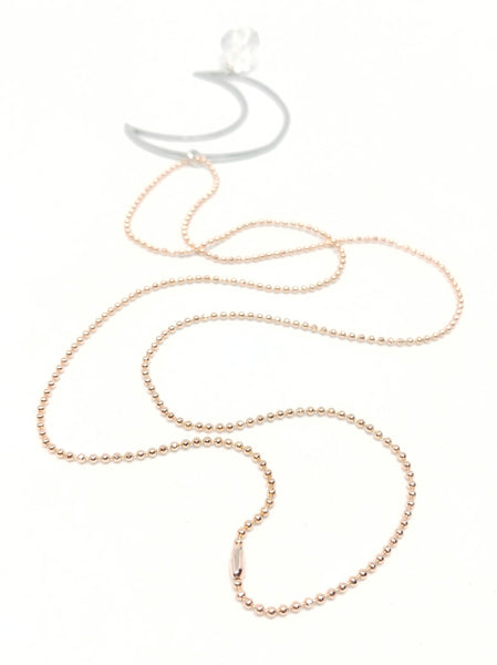 Quartz Moon Necklace featuring rose gold-plated ball chain and silver-plated crescent pendant with faceted quartz nugget.  This photo features a close up of the chain to show off it's sparkle.