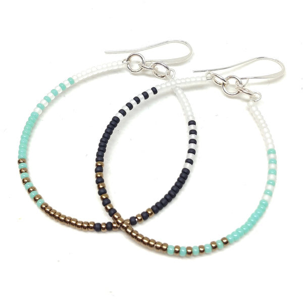 Calm Hoops: Silver-plated ear wires, 2" hoops, white, black, bronze and turquoise seed beads.