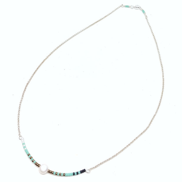 Calm necklace: Sterling silver chain with focal piece featuring white, turquoise, bronze and black seed beads with single pearl.