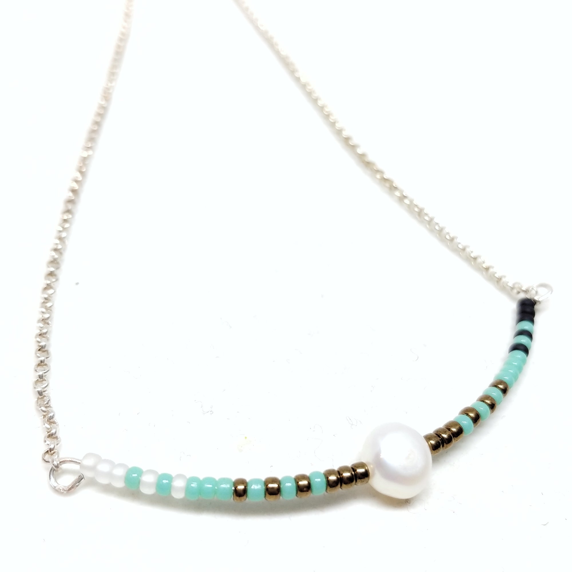 Calm necklace: Sterling silver chain with focal piece featuring white, turquoise, bronze and black seed beads with single pearl.