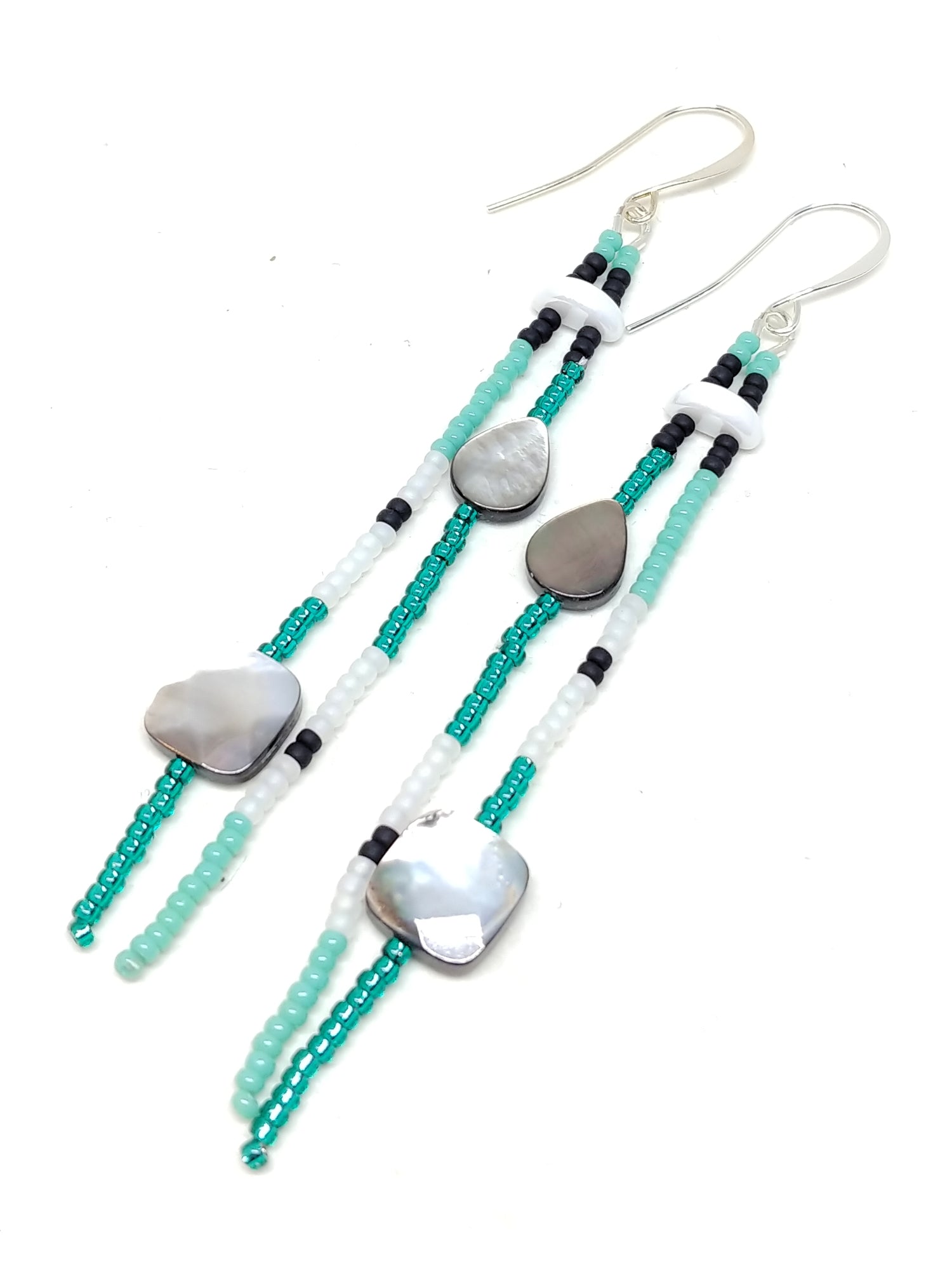 Energy dangles: silver plated, featuring black lip mother of pearl, and seed beads in turquoise, black, white and emerald.