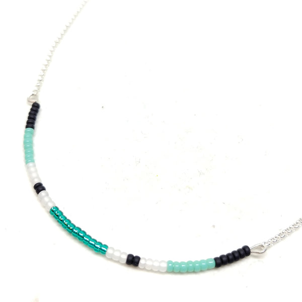 Energy Necklace: sterling silver, 19", centerpiece features seed beads in black, turquoise, white and emerald.