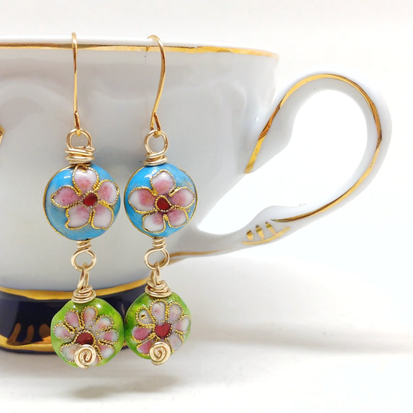 Gold cloisonné bauble earrings featuring vibrant blues and greens with daisy motifs.