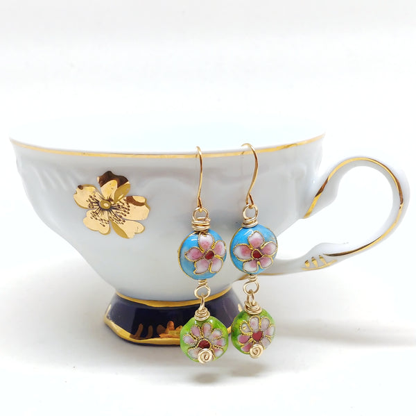 Gold cloisonné bauble earrings featuring vibrant blues and greens with daisy motifs.