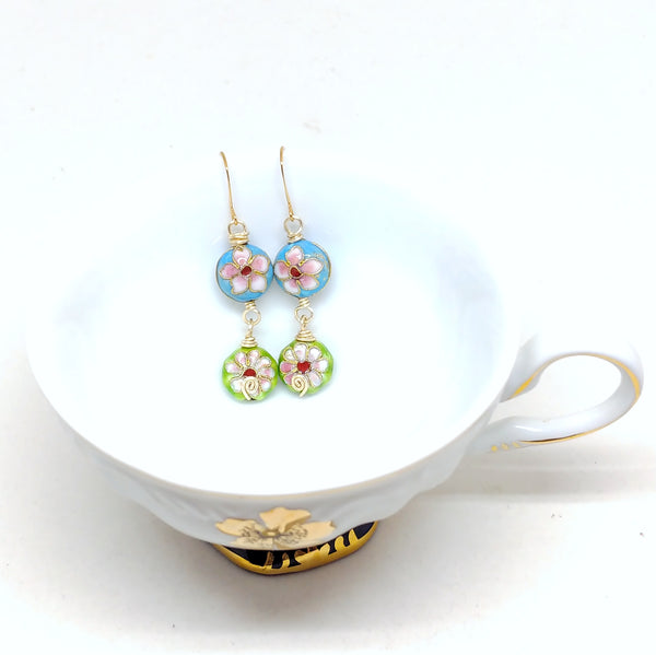 Gold cloisonné bauble earrings featuring vibrant blues and greens with daisy motifs.