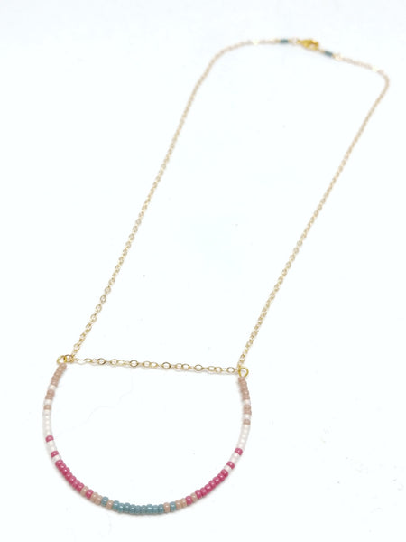 Gratitude Necklace: Gold plated delicate chain, U-shaped focal piece featuring seed beads in beige, white, mulberry and cyan.