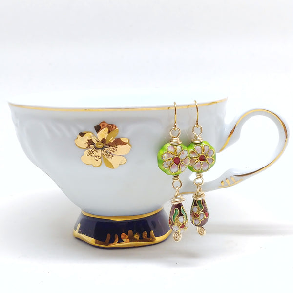 Gold dangly cloisonné bauble earrings featuring vibrant green and burgundy with daisy motifs.