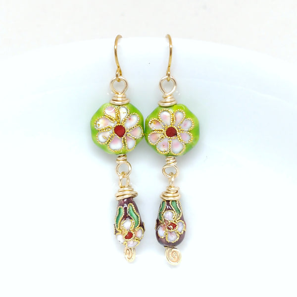 Gold dangly cloisonné bauble earrings featuring vibrant green and burgundy with daisy motifs.