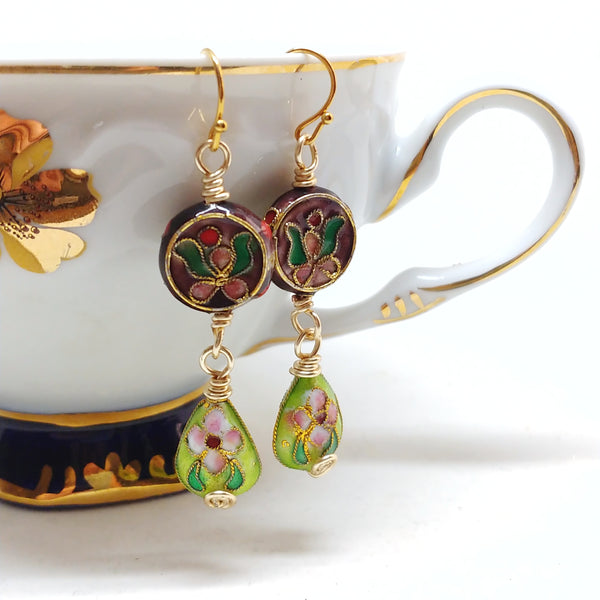 Gold dangly cloisonné bauble earrings featuring vibrant burgundy and green with orchid and daisy motifs.