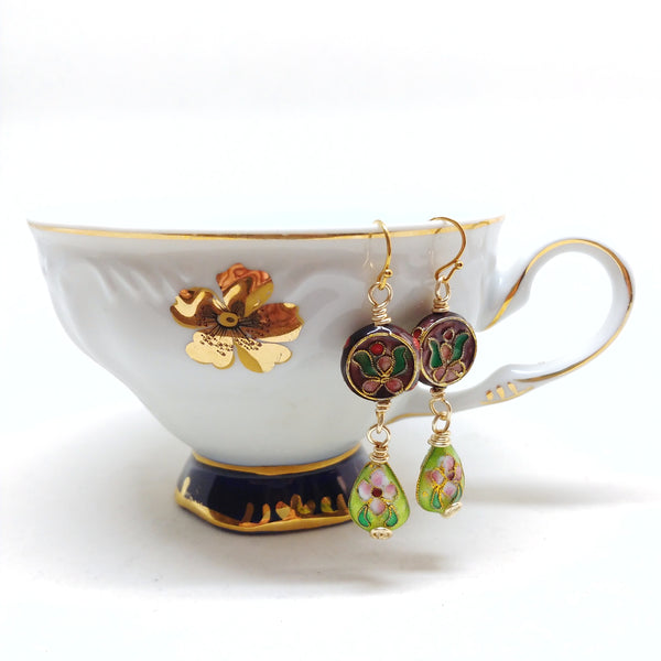 Gold dangly cloisonné bauble earrings featuring vibrant burgundy and green with orchid and daisy motifs.