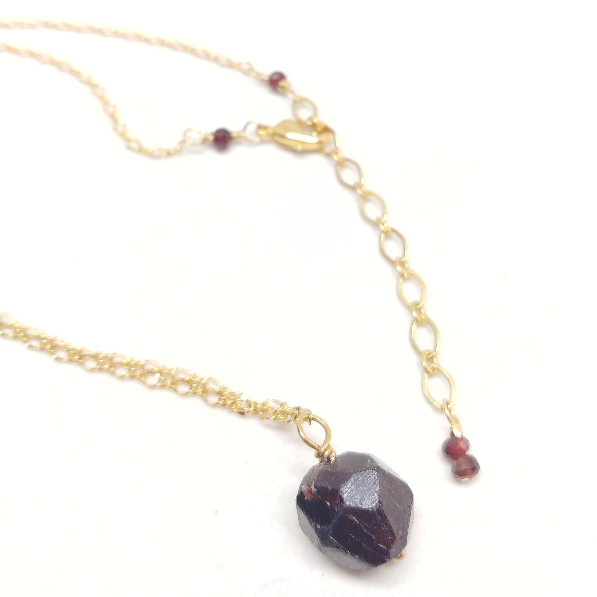 Gold plated delicate chain necklace with a raw garnet bead pendant
