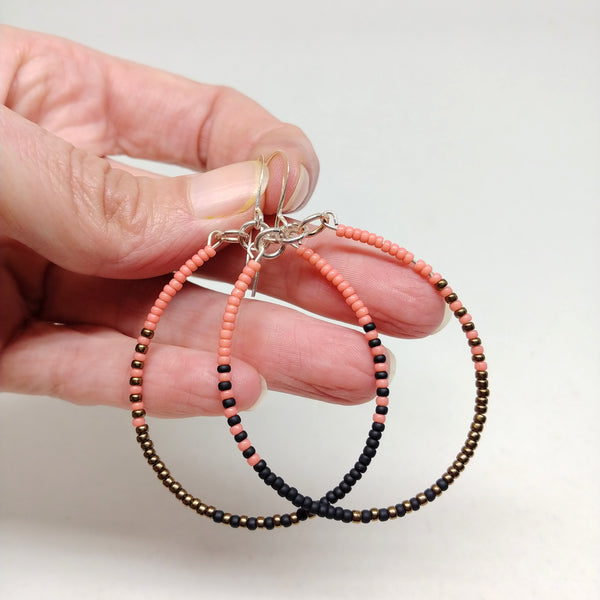 Ready To Rise Hoops: Silver wires featuring seed beads in salmon, black and bronze.