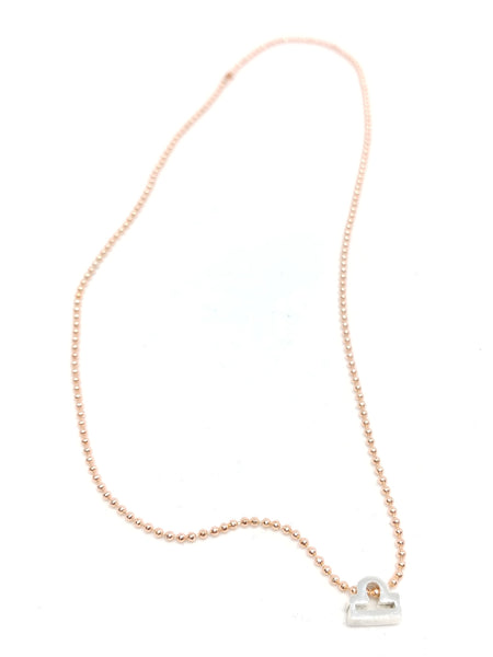 Zodiac choker featuring rose gold-plated ball chain and single silver-plated zodiac charm.