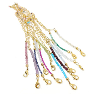 Birthstone bracelets featuring gold paper clip chain and tiny raw or faceted birthstone strands.