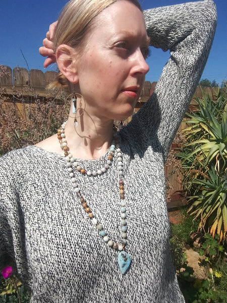 Model wearing Larimar Mala Necklace doubled up with pendant at chest length, paired with Calming Waters Earrings.