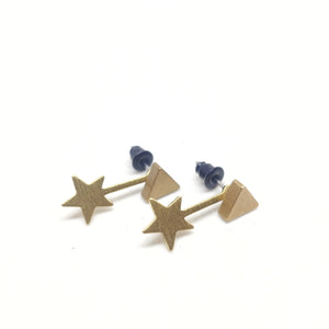 Small brass pyramid studs with brass falling star charms worn as ear jackets (behind the earlobe).