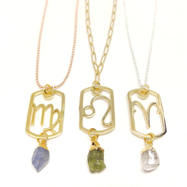 Gold Zodiac Dog Tag pendants with raw birthstones and displayed on choice of chain: rose gold-plated ball chain, gold-plated paper clip chain or sterling silver rolo chain.